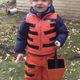 “Cold baby tiger.” Orange snow suit, electrical tape and headband on two-year-old child, 2016.